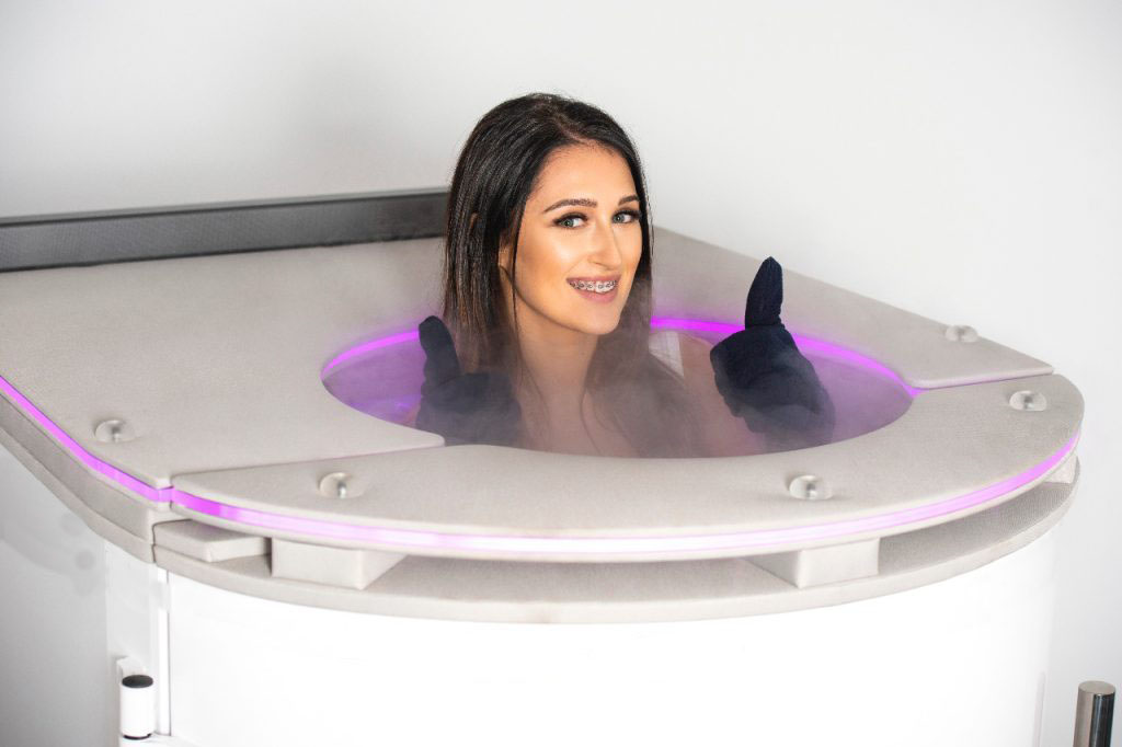 Girl inside cryotherapy machine